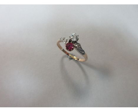 A ruby and diamond two stone ring, with a round brilliant cut diamond and round cut ruby claw set one over the other with dia