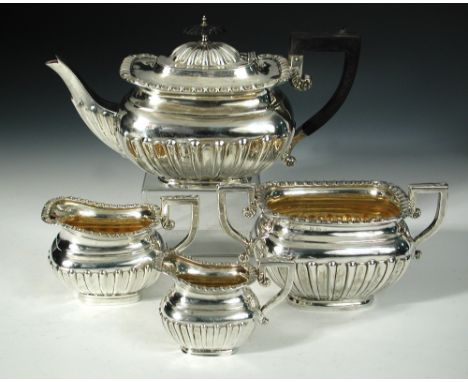 An Edwardian matched silver four piece teaset, comprising:- a teapot by William Aitken, Birmingham 1905, of rectangular half 