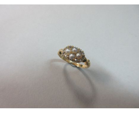 A 19th century diamond, pearl and 18ct gold ring, the front panel set with a horizontal diaper of four 3.5mm half pearls, the