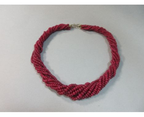 An eight strand necklace of graduated ruby beads, the polished bouton beads, 3-6mm diameter, to a textured S hook clasp, leng
