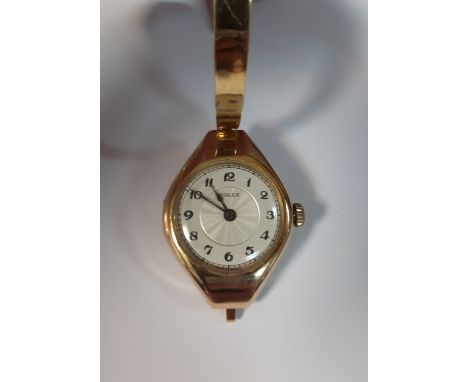 Rolex - a lady's 15ct gold cased manual wind wristwatch, with silver coloured dial printed in black with Roman numerals, sign