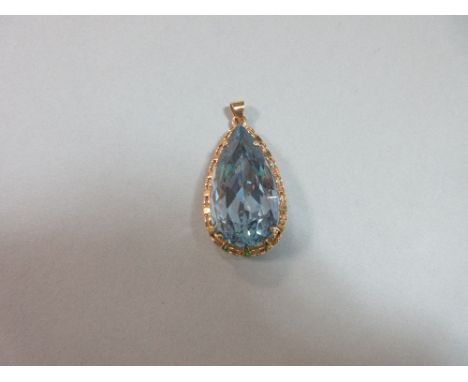 A synthetic pale blue spinel pendant mounted in 18ct gold, the large pear cut light blue spinel, assumed to be of synthetic o