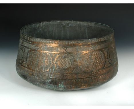 A monumental 15th century Islamic Mamluk tinned copper basin, of sheet metal, hammered and engraved, the body comprising a de