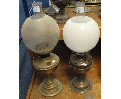 Brass double burner oil lamp with brass baluster reservoir on conical brass base, having etched glass shade and clear chimney