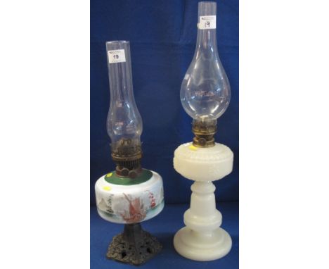 Early 20th Century brass double burner oil lamp with landscape painted ceramic reservoir on cast metal base with glass chimne