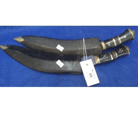 Two Nepalese Kukri fighting knives, each with leather scabbard, containing additional small knives (one missing). (2)