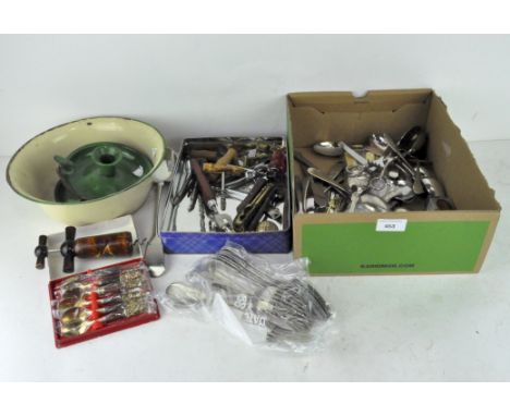 A selection of plated flatware and various corkscrews, together with two enamel chamber sticks and an enamel bowl