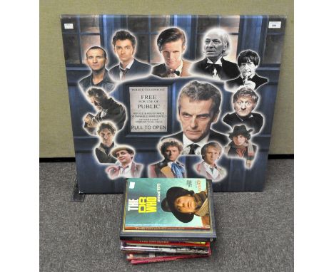 A large Doctor Who print on canvas on a frame, 71 x 71 cm, together with various 1970s and 1980s Doctor Who annuals