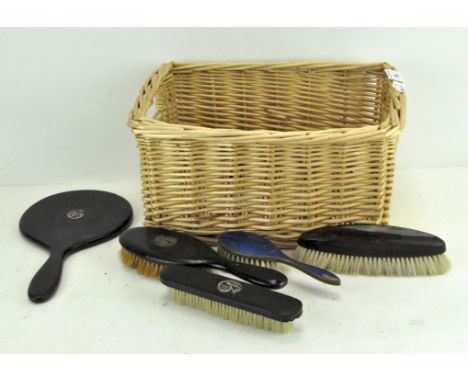 A set of Edwardian ebonised part dressing table set, a simulated tortoiseshell mounted brush, an Art Deco guilloche enamel br