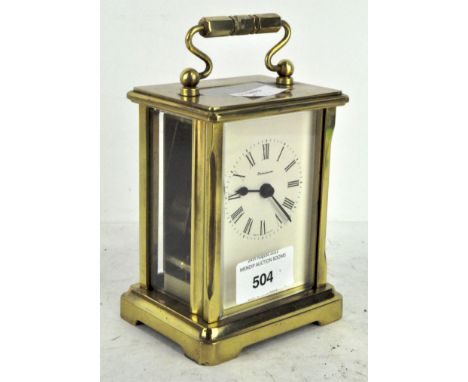 A 20th century brass cased carriage clock by Dominion, made in England, the white dial with Roman numerals denoting hours, 13