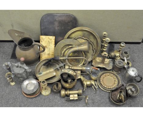 A collection of assorted vintage metalware including candlesticks, a large ewer and trays