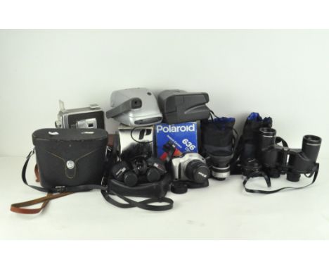 Various vintage cameras and lenses, including Pentax Asahi, Kodak Brownie Movie Camera and other examples