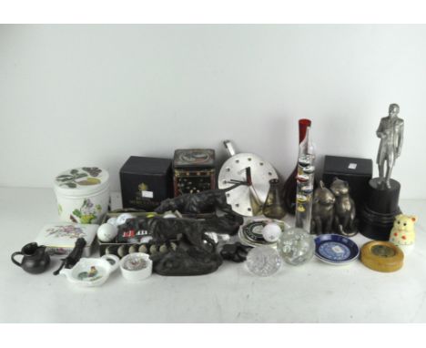 A group of collectables, including a Jaguar car badge, golf balls and ornaments