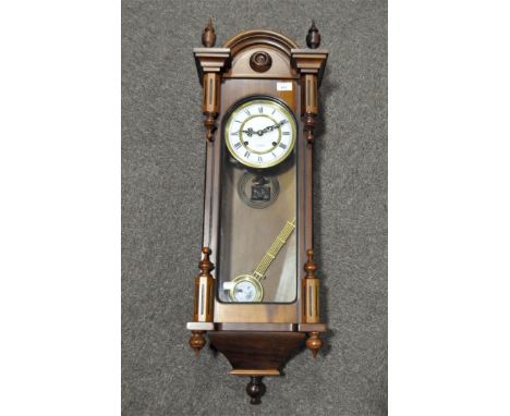 A Vienna-style regulator clock, 31 day, with white enamel dial and Roman numerals, in arched rectangular wooden case, with sp