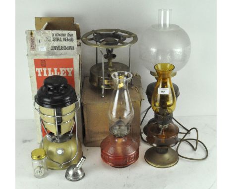 A selection of vintage lamps and lanterns of brass and amber and clear glass, together with a Tilly Storm light, Model X246B,