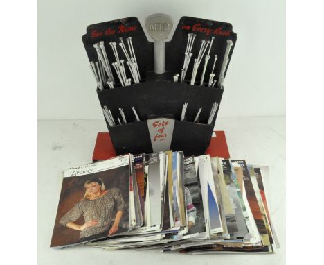 A vintage Aero Shop display stand of knitting needles, together with a box of patterns