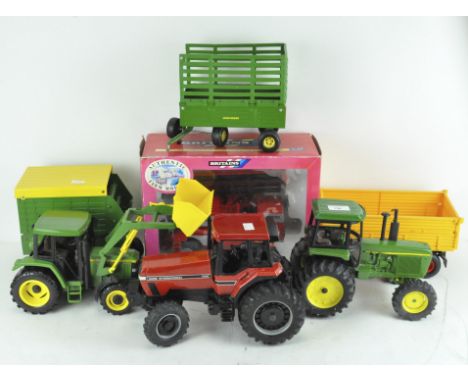 A selection of model tractors and related farming equipment, including a Britains Massey Ferguson 7200 combine harvester, in 