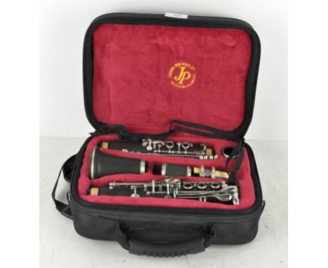 A cased John Packer clarinet, JP124 C Full System Ebonite Black, with original receipt