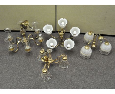 Four brass and gilt metal chandeliers, with glass shades, comprising: two five light examples and two three light examples, 6