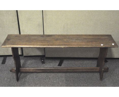 A vintage pine bench, with cross stretcher and shaped upright supports, 52 cm high x 128 cm wide x 30 cm deep 