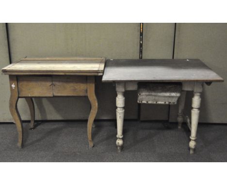 A vintage Hungarian kitchen table with a low drawer and white painted turned legs, together with folding pine kitchen table  