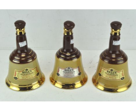 Three 20th century Bells old scotch whisky wade ceramic decanters, each with contents