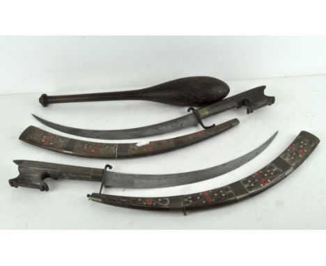 Two decorative brass and wood-mounted swords and scabbards, together with a turned wooden bat, the first sword scabbard inlai