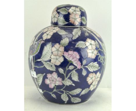 A 20th century Chinese porcelain oviform vase and domed cover, printed and painted with pheasant amongst flowers on a blue gr