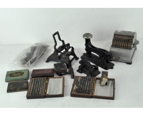 A collection of vintage stationery equipment, including a printing press, blocks, a Precise (Chicago) machine and other items
