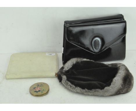A selection of vintage items, including two patent leather handbags, a fur hat, a white leather letter writing set, and a Str