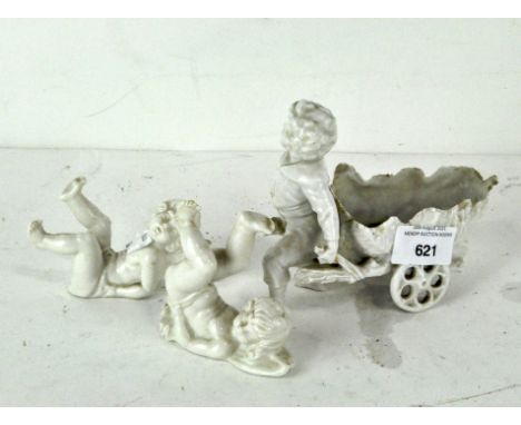 Three 20th century German white glazed ceramic figures comprising a figure of a boy pulling a vine cart (AF), height 12 cm; t