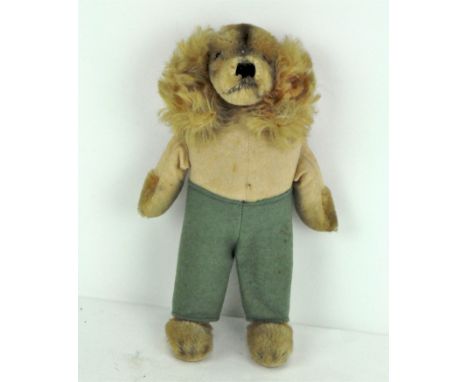 A rare 1950's Steiff Waldili Hunter dog, wearing green trousers, with yellow label and metal button, 22 cm high 
