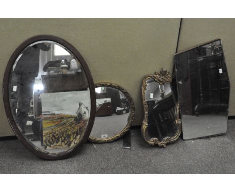 Four vintage mirrors, the largest of oval form, 51 cm x 73 cm; one with gesso frame topped with a cherub, and two others