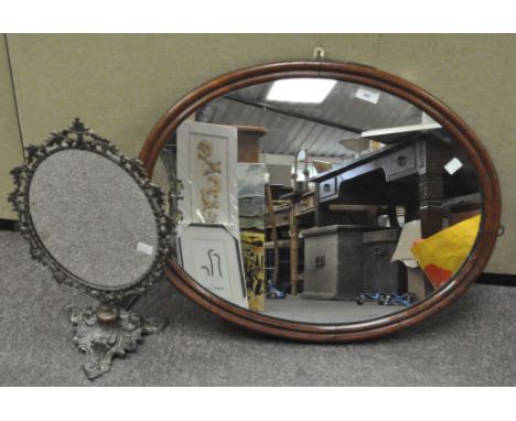 A vintage oval wall mirror in a wood frame, 53 cm x 68 cm, together with a brass framed table mirror with leaf surround, heig