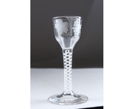 A GEORGIAN WINE GLASS, the bowl engraved with fruiting vines, with white air twist stem. 5.5ins high.