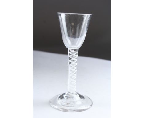 A GEORGIAN WINE GLASS with white circular twist stem. 5.5ins high.