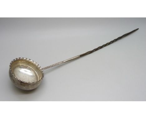 A white metal toddy ladle with baleen handle 