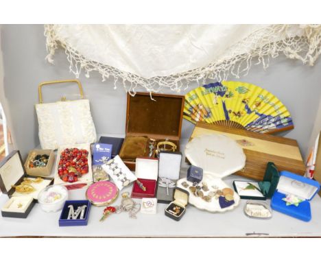 A collection of costume jewellery including brooches, necklaces, a compact, a beaded bag, etc.