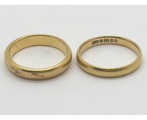A 22ct Gold Wedding Band, (finger size L1/2), together with another example of a similar style, (finger size K). (2)