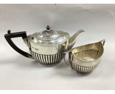 A Hallmarked Silver Tea Pot, Messrs Hutton, London 1896, of oval semi reeded form; Together with Matching Hallmarked Silver T