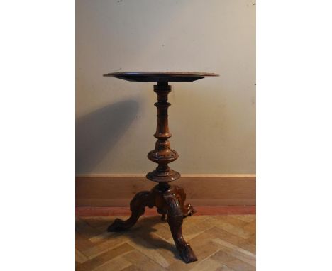 A 19th century burr walnut occasional table with carved moulded top with central inlaid cartouche raised on turned central co