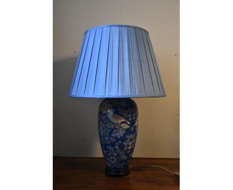 A contemporary baluster form table lamp decorated in bird and flower decoration with pale blue pleated shade. H.78 Dia.24cm (