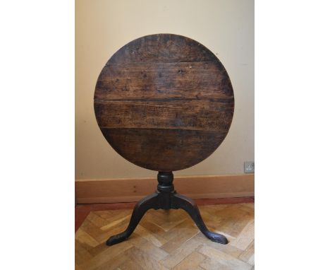 A Georgian country oak tilt top table on tripod cabriole supports. H.66 Dia.70cm (H.104cm tilted) 