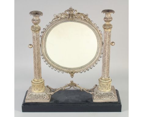 A VERY FINE AND LARGE 19TH CENTURY OTTOMAN TURKISH PARCEL GILT FILIGREE SILVER MIRROR, on a later wooden stand, the mirror wi