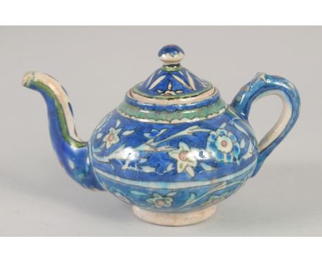 A PALISTINIAN GLAZED POTTERY TEAPOT, with foliate decoration, 19cm spout to handle.