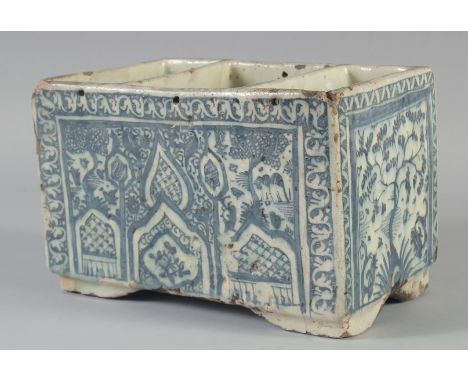 A RARE LARGE 17TH CENTURY PERSIAN SAFAVID BLUE AND WHITE GLAZED POTTERY BOX, with three open compartments and raised on four 