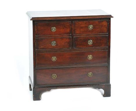 GEORGIAN MAHOGANY COMMODE CHEST OF TWO DOORS ABOVE TWO DRAWERS ON BRACKET FEET WITH BRASS RING HANDLES.HEIGHT: 28 INCHES, WID