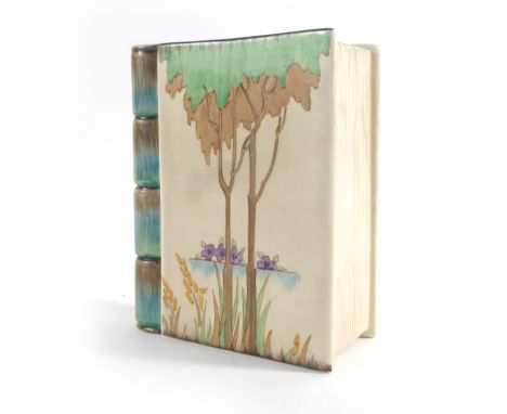 Clarice Cliff for Wilkinsons, a vase in the form of a closed book decorated with trees and flowers, h. 18.5 cm   CONDITION RE