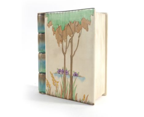 Clarice Cliff for Wilkinsons, a vase in the form of a closed book decorated with trees and flowers, h. 18.5 cm   CONDITION RE