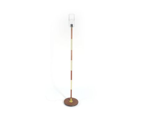 A 1970's teak and brass coloured standard lamp   CONDITION REPORT:  Working order unknown and not guaranteed. Some wear